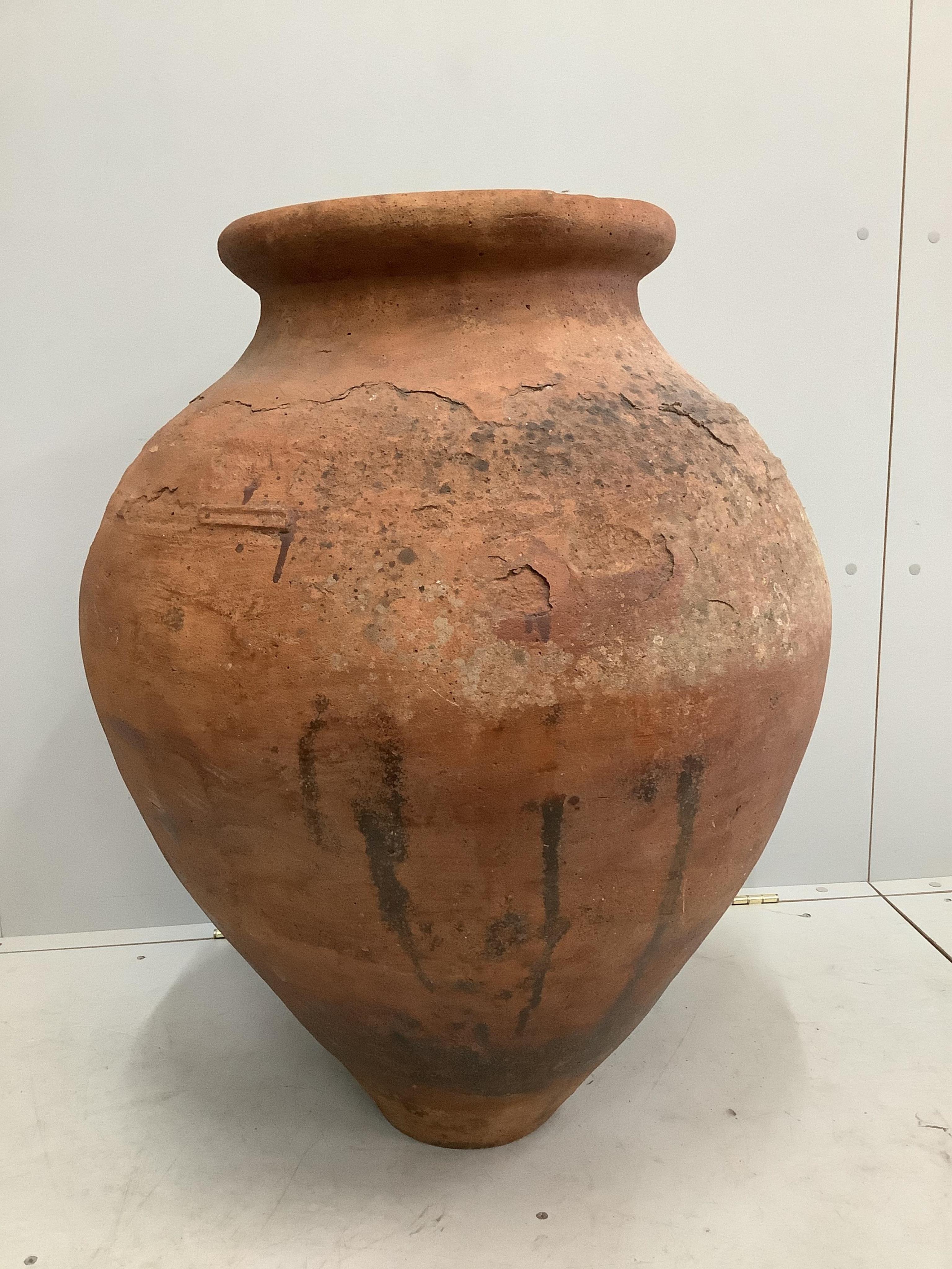 A large earthenware amphora, height 85cm. Condition - fair